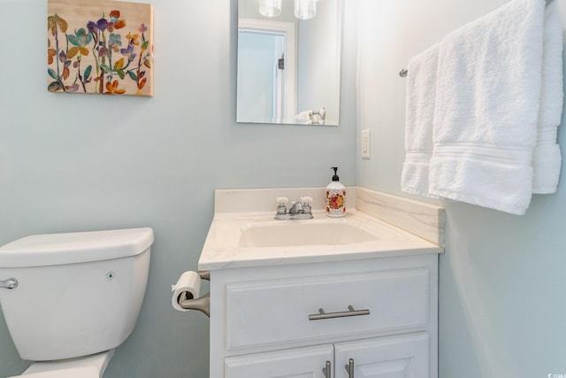 half bathroom featuring toilet and vanity