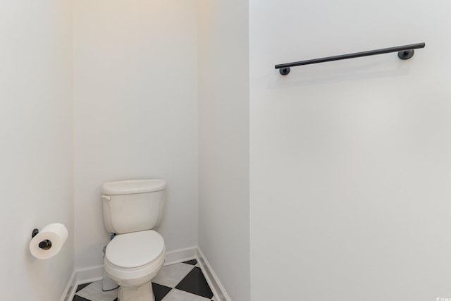 bathroom featuring toilet and baseboards