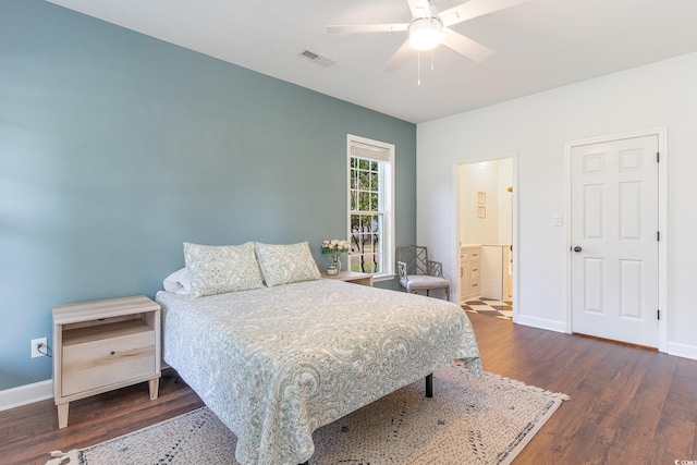 bedroom with connected bathroom, wood finished floors, visible vents, and baseboards