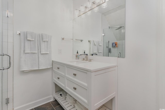 bathroom with baseboards, a stall shower, and vanity