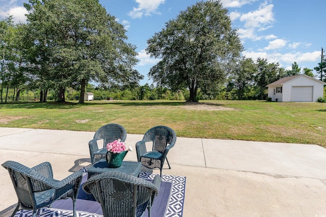 view of patio / terrace with a garage and an outdoor structure