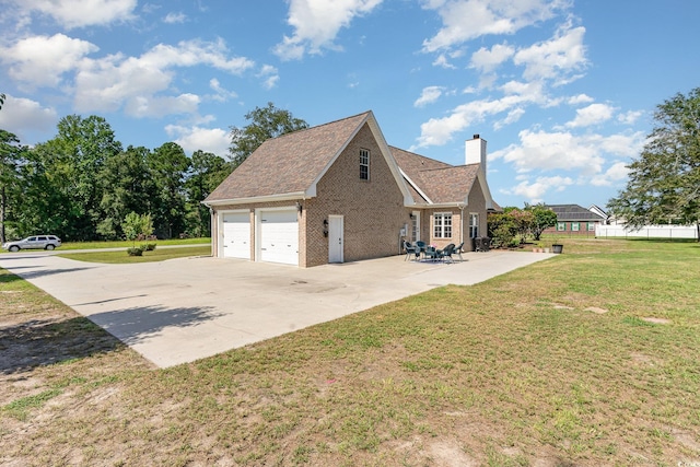 view of side of property featuring a chimney, concrete driveway, a garage, a lawn, and brick siding