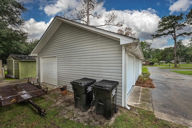 view of property exterior featuring a garage and a storage shed