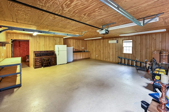 garage featuring a garage door opener, wooden walls, and white refrigerator