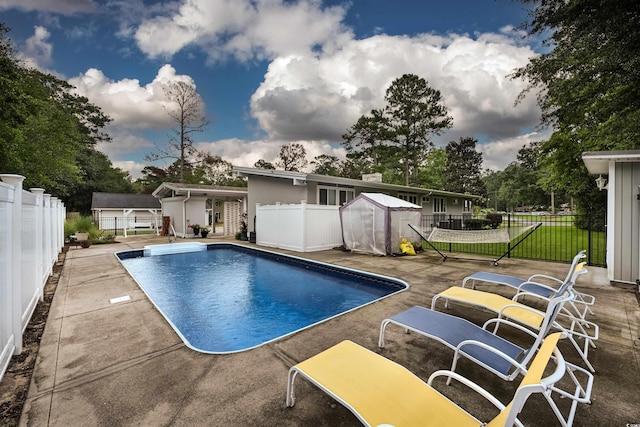 view of pool with a storage shed