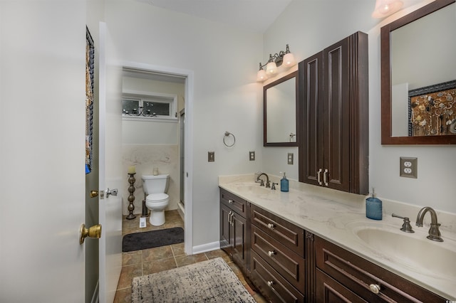 bathroom featuring vanity, toilet, and tile patterned floors