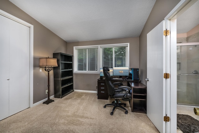 office area with light carpet and a textured ceiling