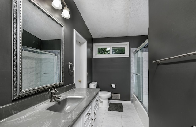 full bathroom featuring shower / bath combination with glass door, vanity, toilet, and a textured ceiling