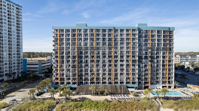 view of building exterior with a community pool