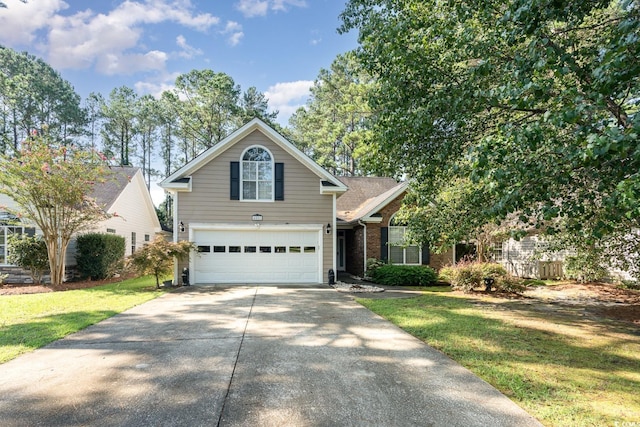 view of property with a front yard and a garage