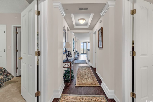 hall with dark hardwood / wood-style flooring and a tray ceiling