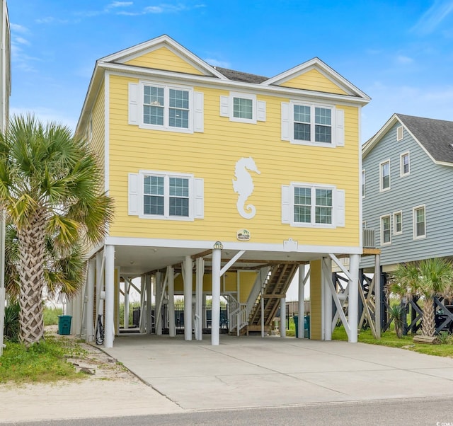 raised beach house featuring a carport