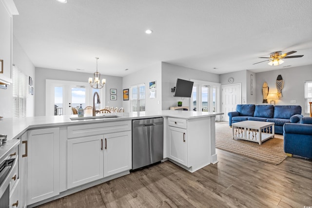 kitchen with plenty of natural light, white cabinets, and sink