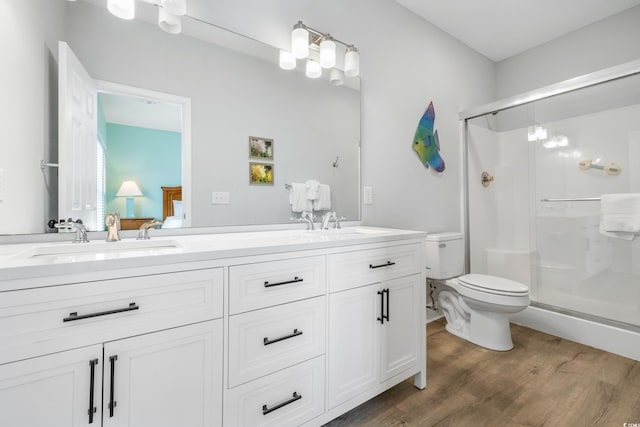 bathroom with vanity, walk in shower, toilet, and wood-type flooring