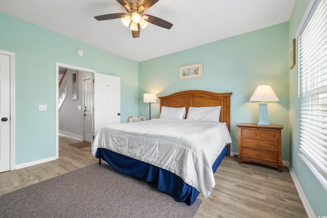 bedroom with ceiling fan and light hardwood / wood-style flooring