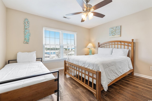 bedroom featuring ceiling fan and dark wood-type flooring