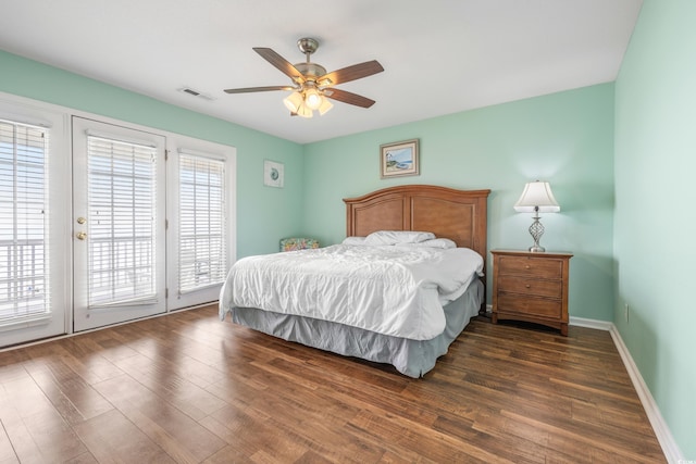 bedroom with access to exterior, multiple windows, ceiling fan, and dark hardwood / wood-style flooring