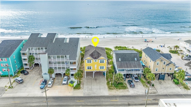 aerial view with a water view and a beach view