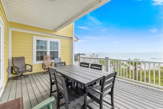 wooden deck featuring a water view and a view of the beach