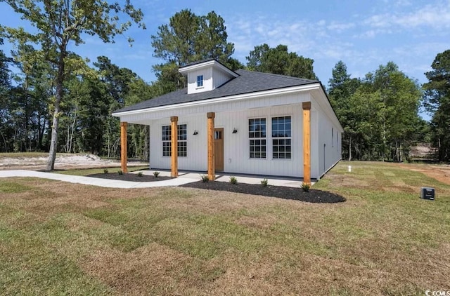 view of front of property with a porch and a front yard