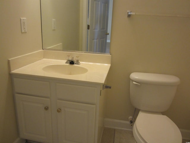 bathroom featuring tile patterned flooring, vanity, and toilet