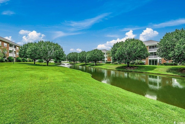 surrounding community with a lawn and a water view