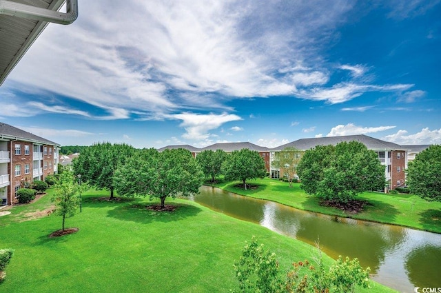 view of property's community featuring a water view and a lawn