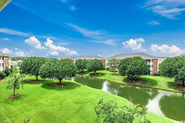 view of community with a water view and a yard