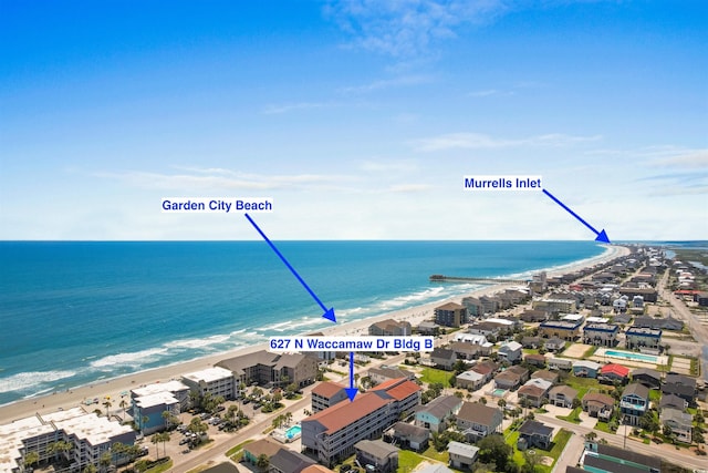 bird's eye view featuring a water view and a view of the beach