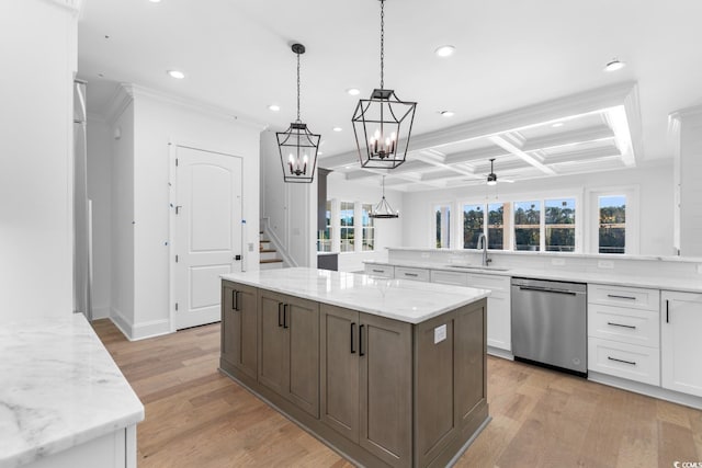 kitchen with stainless steel dishwasher, plenty of natural light, light wood-type flooring, and white cabinetry