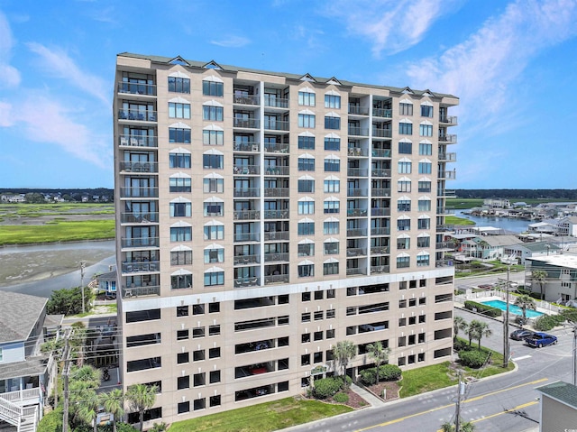 view of property featuring central AC and a water view