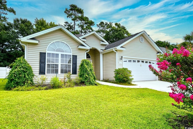 view of front of house featuring a front yard and a garage