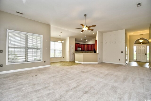 unfurnished living room featuring lofted ceiling, ceiling fan, and light tile patterned flooring