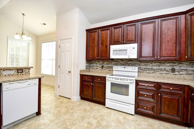 kitchen with light tile patterned floors, white appliances, a notable chandelier, lofted ceiling, and tasteful backsplash