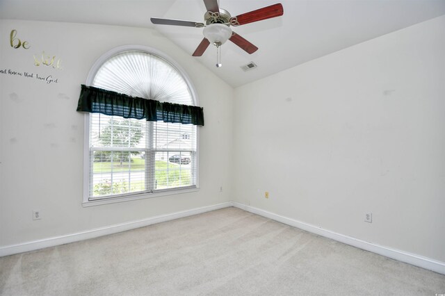 carpeted empty room featuring vaulted ceiling and ceiling fan