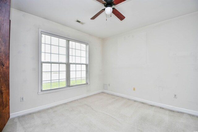 empty room with light colored carpet and ceiling fan