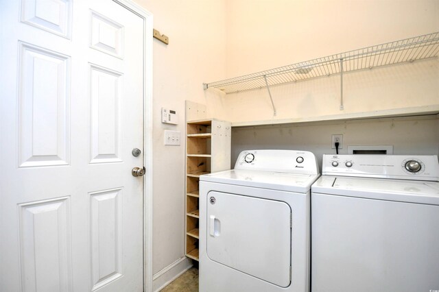 clothes washing area with separate washer and dryer