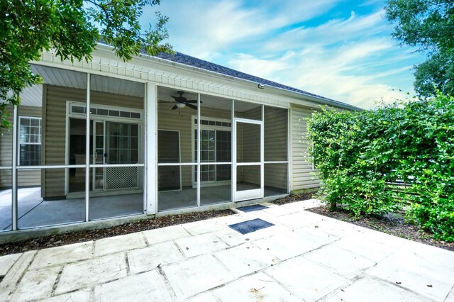 back of property featuring a patio area, a sunroom, and ceiling fan