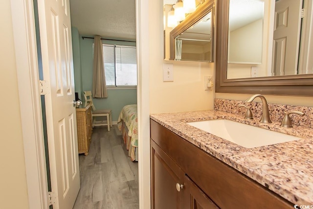 bathroom featuring hardwood / wood-style flooring and vanity