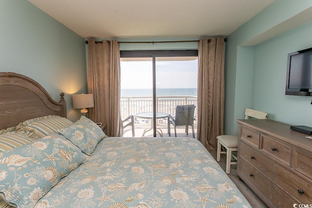 bedroom with wood finished floors and access to exterior
