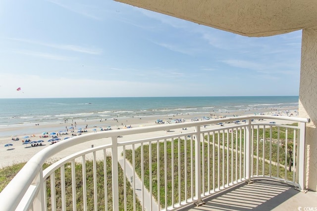 balcony with a beach view and a water view