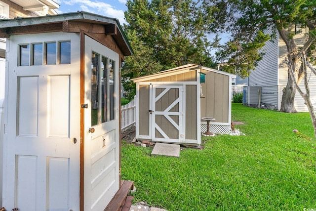 view of outbuilding with a yard