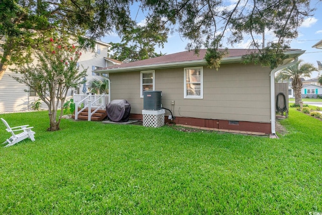 rear view of house featuring a lawn