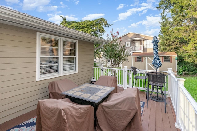 wooden terrace featuring an outdoor structure