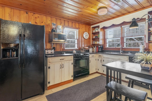 kitchen with wooden ceiling, sink, black appliances, light tile patterned flooring, and wood walls