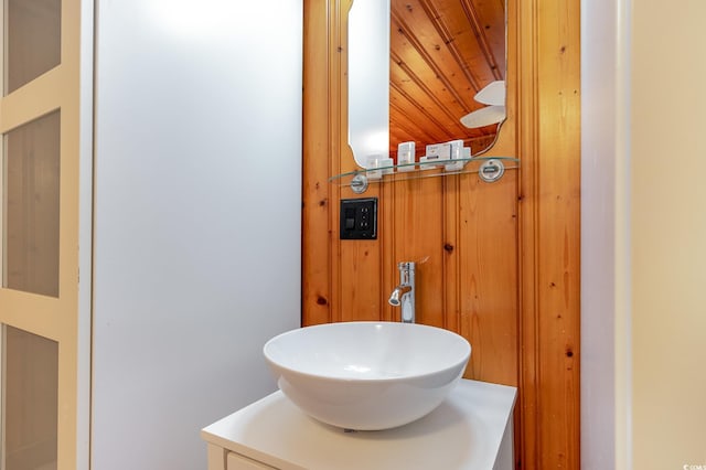 bathroom with wood ceiling and vanity