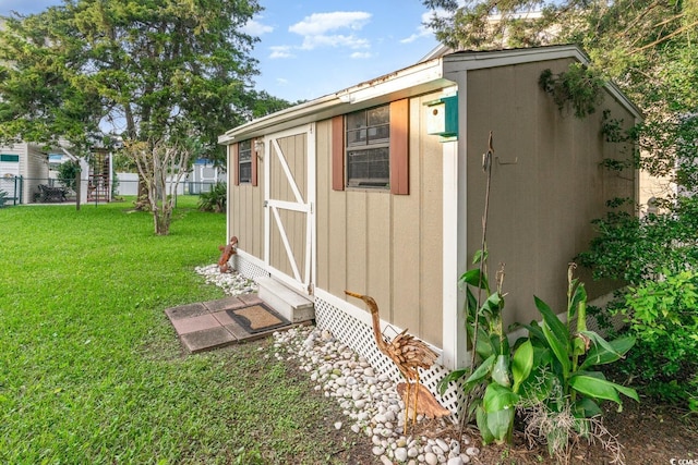 view of outbuilding featuring a lawn