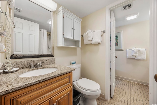 bathroom with toilet, vanity, curtained shower, and tile patterned floors