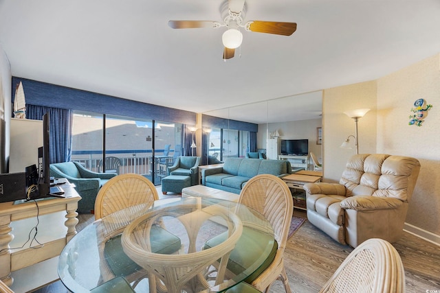 living room with ceiling fan and wood-type flooring