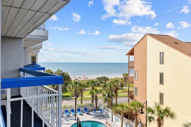 exterior space with a water view, a patio, and a community pool